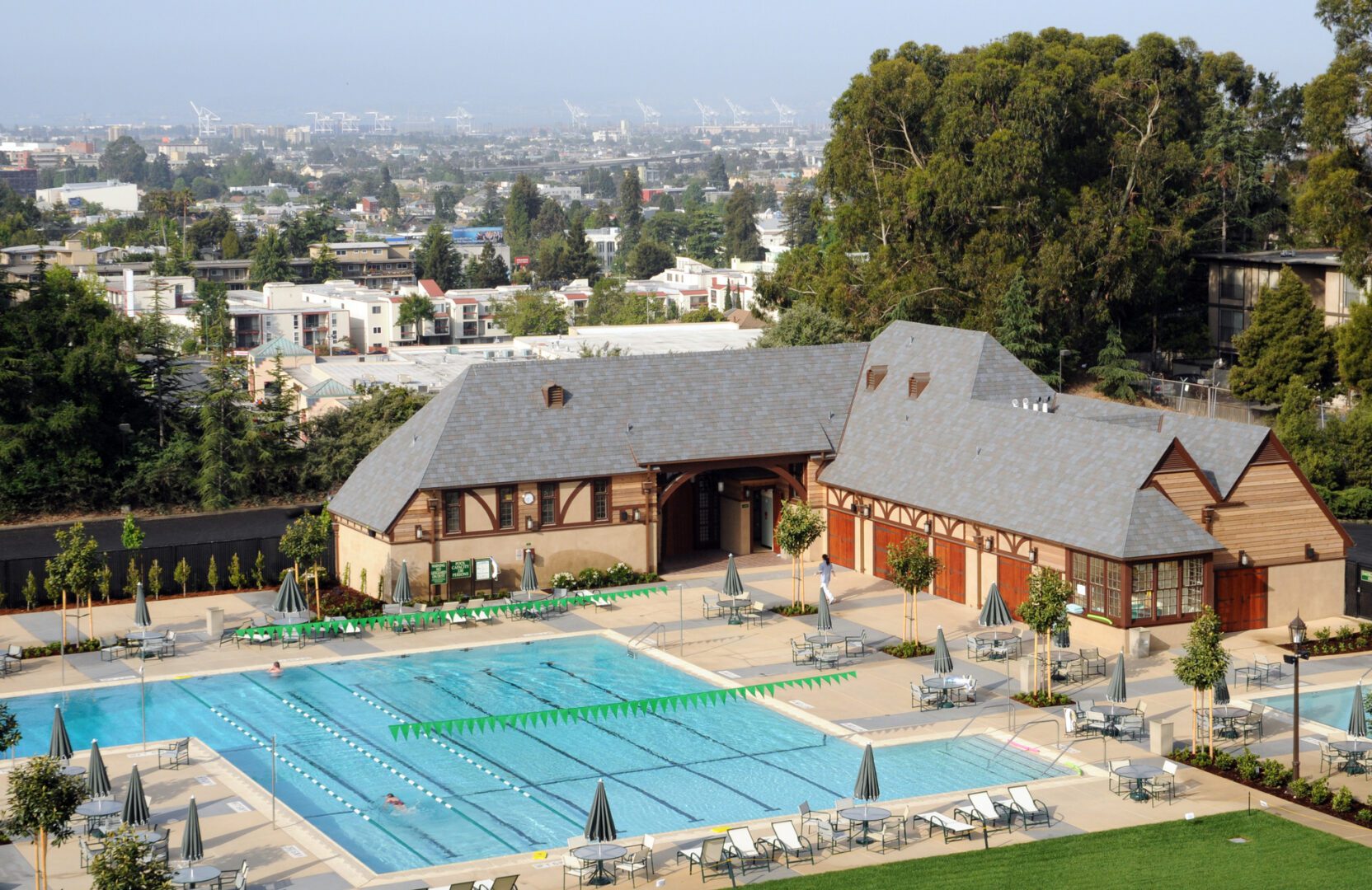 A large swimming pool with many chairs around it