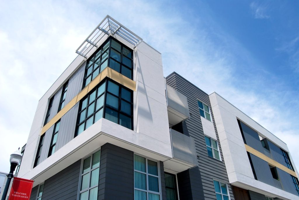 A building with many windows and balconies on the outside.