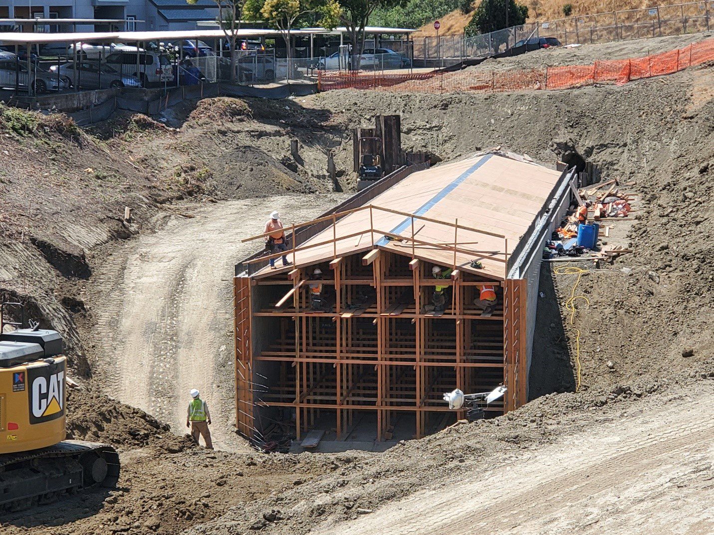 A construction site with workers working on the ground.