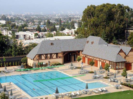 A large swimming pool with many chairs around it