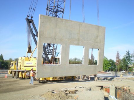 A crane lifting a large concrete block.