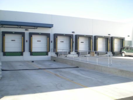 A row of white loading docks in front of a building.