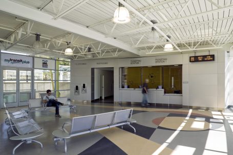 A lobby with people waiting at the counter.