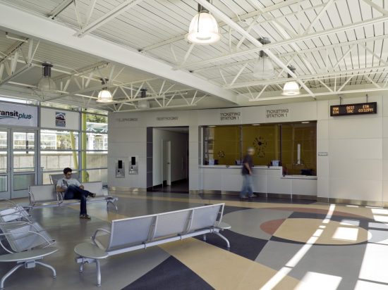 A lobby with people waiting at the counter.