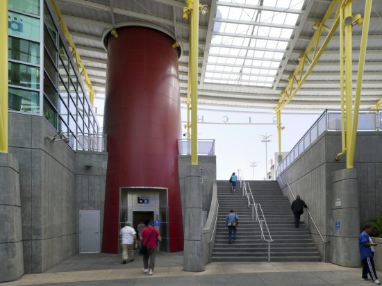 A red tower with people walking up the stairs.