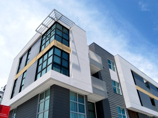 A building with many windows and balconies on the outside.