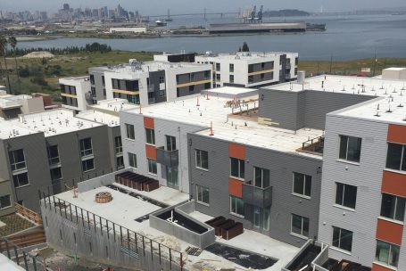 A view of some buildings and the ocean.