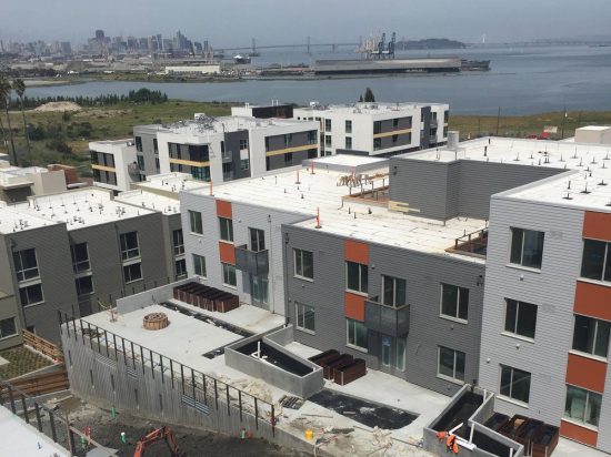 A view of some buildings and the ocean.