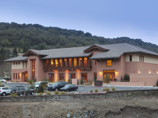 A large building with many windows and lights on it