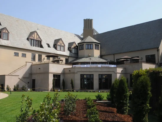 A large building with many windows and trees