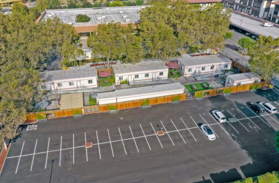 A parking lot with cars parked in it and some buildings