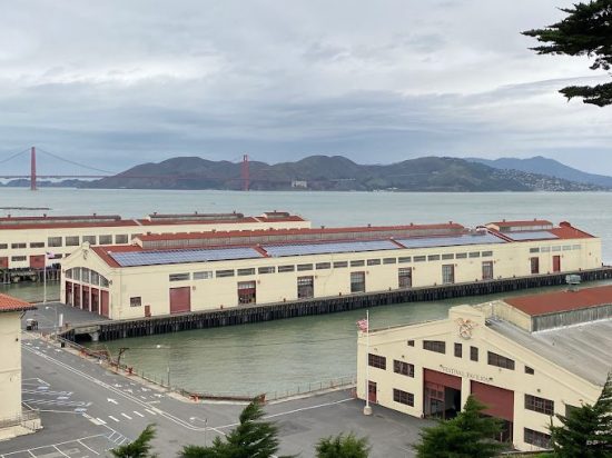 A large warehouse with many windows and doors.