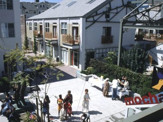 A group of people standing around in an outdoor area.