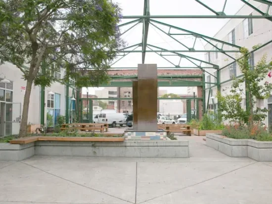 A courtyard with benches and a fountain.